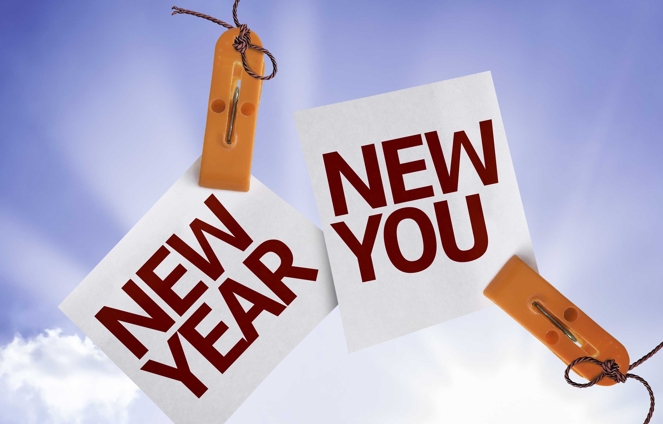 pieces of paper that say new year and new you